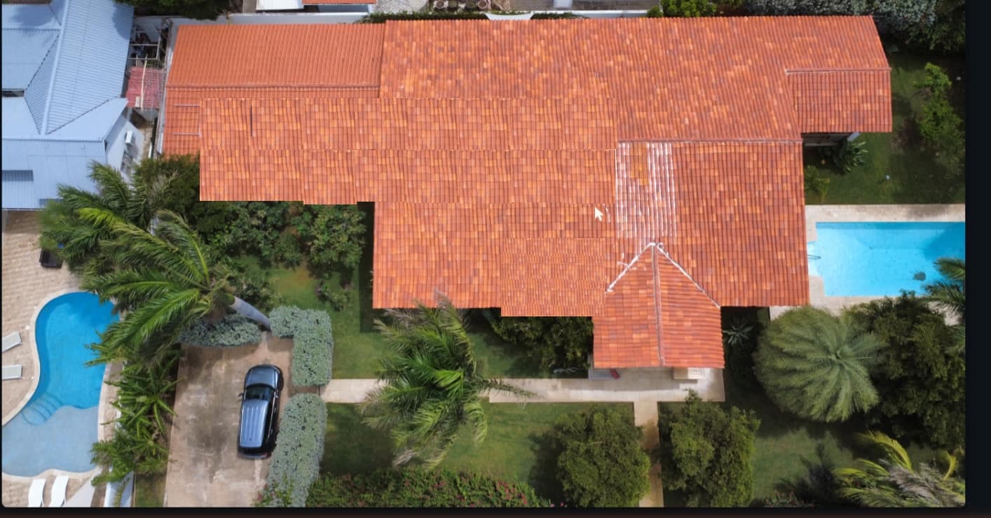Aerial drone photo of a roof with a to-scale solar panel layout and measurements overlaid
